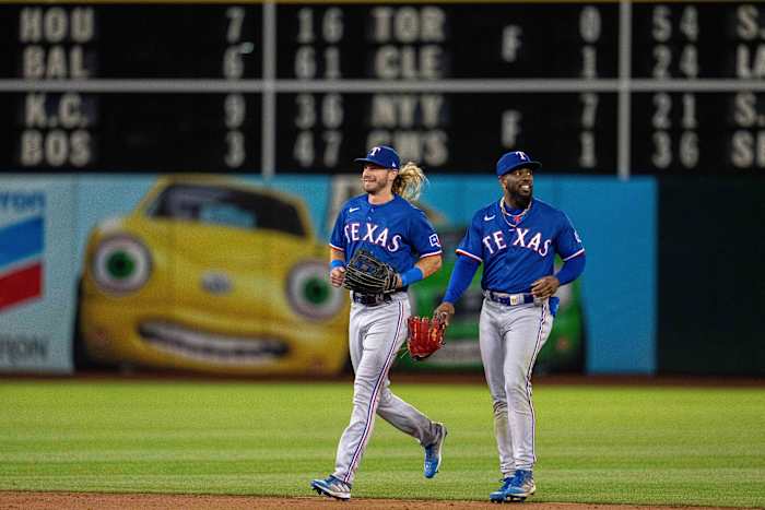 Texas Rangers left fielder Travis Jankowski, left, and right fielder Adolis Garcia celebrate after the club's eighth consecutive win to start August against the Oakland Athleticst on Aug. 8 at Oakland-Alameda County Coliseum.